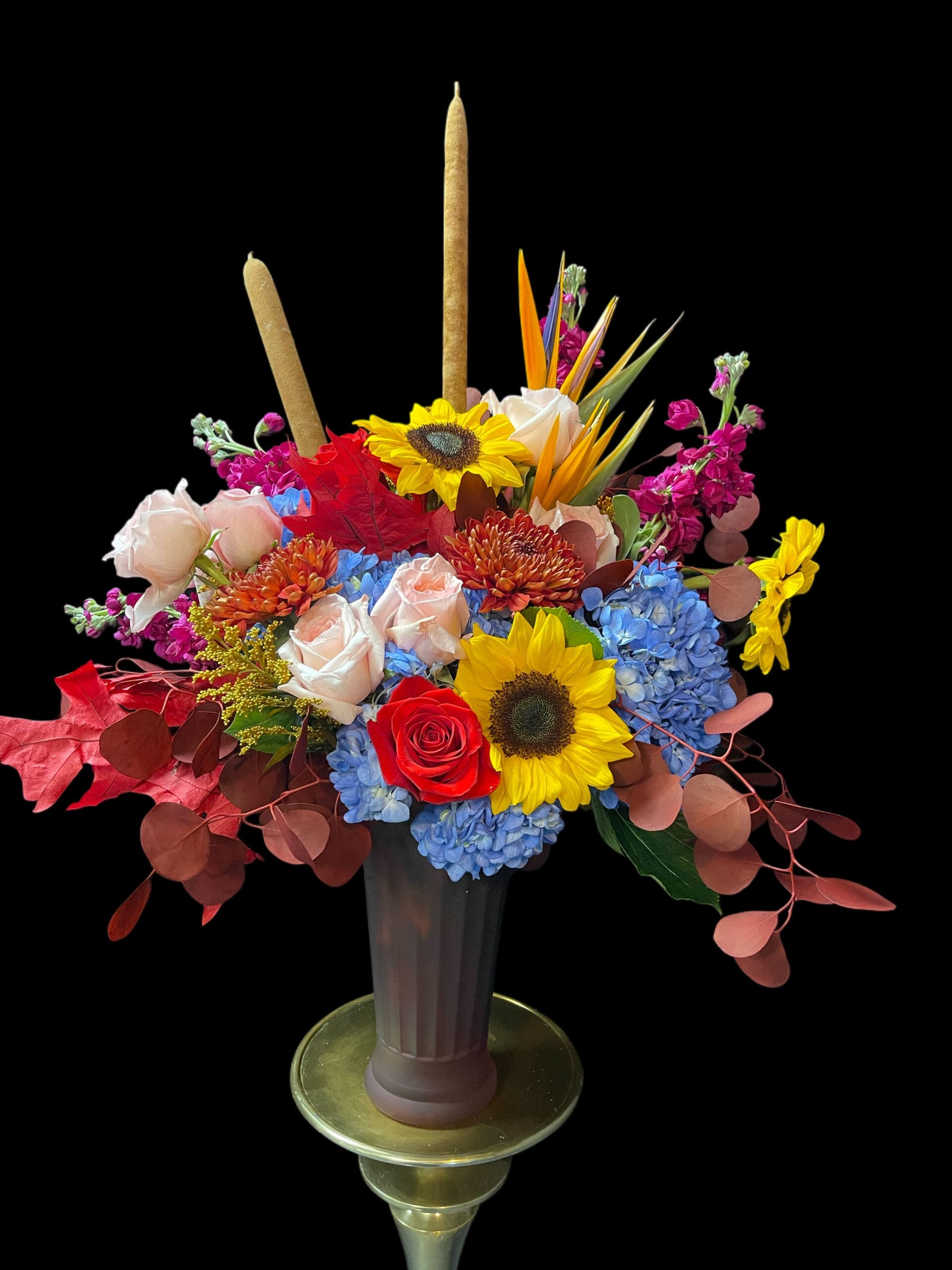 Candlelit celebration centerpiece in citrus and sapphire tones in a brass urn, event florals by Naples Picasso Flowers, Naples FL
