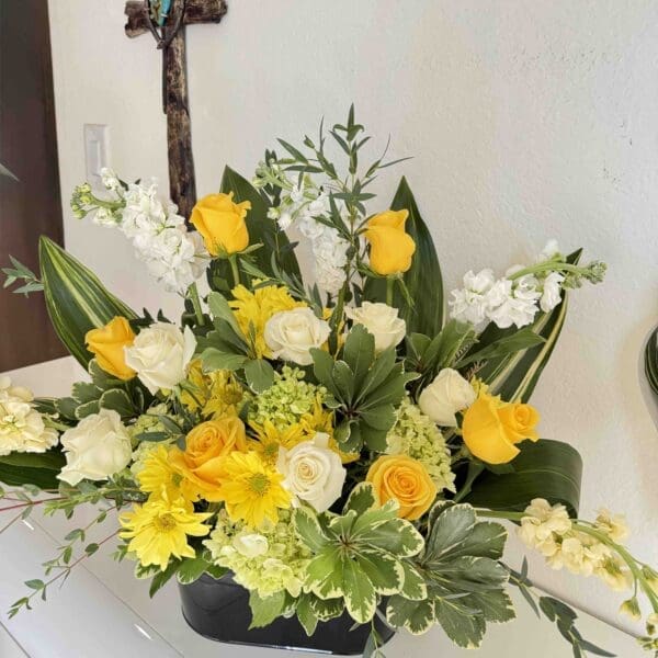 Yellow and white funeral altar arrangement with roses, hydrangea, stock and greenery in Naples Florida.