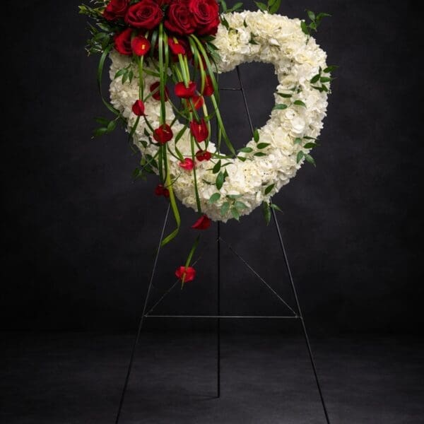 Luxury white hydrangea open heart funeral spray with red roses and red calla lilies in Naples Florida.