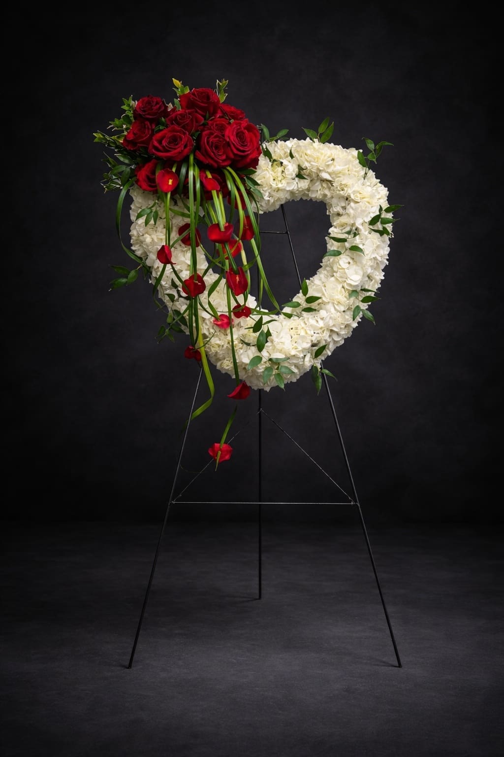 Funeral Hear Spray Luxury white hydrangea open heart funeral spray with red roses and red calla lilies in Naples Florida.